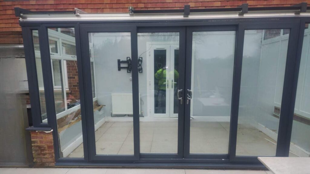 Black frame bi-fold doors fitted in residential property extension